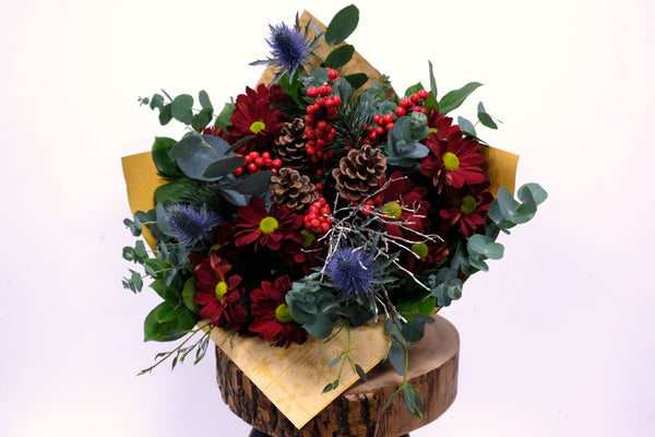 Combination of red berries and thistle with red Chrysanthemum and pine cones. We deliver flowers throughout Dublin and Ireland. Please place your order by 1 pm for Same Day Flower Delivery in Dublin or Next Day Flowers Delivery Ireland and also Raheny Free Delivery 
