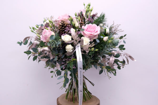 Christmas Pink Roses Flower Bouquet. Combination of pink roses and pink lisianthus with a festive touch of platinum foliage. We deliver flowers throughout Dublin and Ireland. Please place your order by 1 pm for Same Day Flower Delivery in Dublin or Next Day Flowers Delivery Ireland 