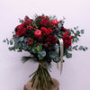 Christmas Nature Flower Bouquet. Red roses, red apples, pine cones, skimmia and dark red carnations in the splendid Christmas hand-tied bouquet. Please place your order by 1 pm for Same Day Flower Delivery in Dublin or Next Day Flowers Delivery Ireland and also Raheny Free Delivery 