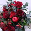 Christmas Nature Flower Bouquet. Red roses, red apples, pine cones, skimmia and dark red carnations in the splendid Christmas hand-tied bouquet. Please place your order by 1 pm for Same Day Flower Delivery in Dublin or Next Day Flowers Delivery Ireland and also Raheny Free Delivery