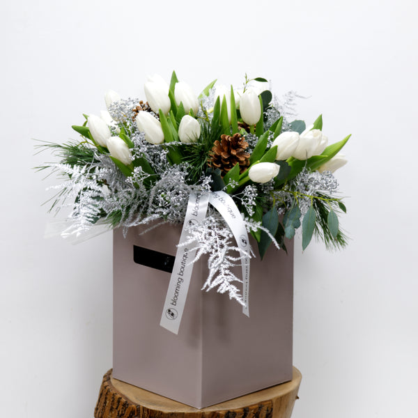 Christmas Tulips Flower Bouquet. The pure beauty of white tulips with a festive touch of pine cones and silver foliage. We deliver flowers throughout Dublin and Ireland. Please place your order by 1 pm for Same Day Flower Delivery in Dublin or Next Day Flowers Delivery Ireland and also Raheny Free Delivery 