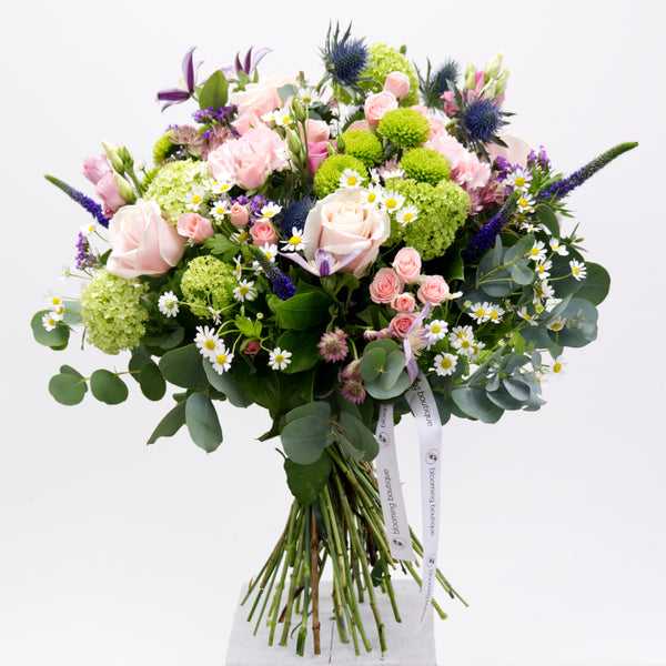 A pastel pink, fresh green and soft lilac colours in a beautiful flower bouquet full of large and spray Roses, Lisianthus, Viburnum, Thistle, Clematis, Tanacetum, Chrysanthemum and Eucalyptus. Please place your order by 1 pm for Same Day Flower Delivery Dublin or Next Day Flowers Delivery Ireland