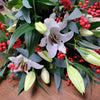 Christmas Lily & Ilex. Stunning scent of white Lilies surrounding with Ilex and festive foliage. Please place your order by 1 pm for Same Day Flower Delivery in Dublin or Next Day Flowers Delivery Ireland and also Raheny Free Delivery