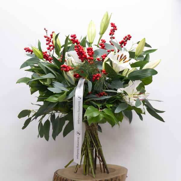 Christmas Lily & Ilex. Stunning scent of white Lilies surrounding with Ilex and festive foliage. Please place your order by 1 pm for Same Day Flower Delivery in Dublin or Next Day Flowers Delivery Ireland and also Raheny Free Delivery 