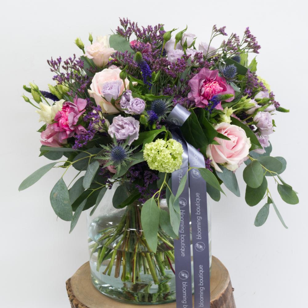 The Country Garden flower bouquet is creatively designed with deep red, dark purple, and various shades of pink blooms. This beautiful flower arrangement is presented in an attractive and modern glass vase to capture your love's heart. Same Day Flower Delivery in Dublin or Next Day Flowers Delivery Ireland